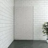 A corner of a room with tiled walls and floor, featuring a large textured panel and a potted plant. Produktbild-Vorschau