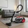 A vacuum cleaner on a rug in a living room. Náhľad obrázku produktu
