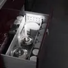 An open kitchen drawer with organized cookware and dishes, illuminated by an LED light strip. Produktbild-Vorschau