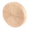 A round, thick pouf made of woven natural material, presented on a white background. Voir les images du produit