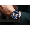 A man's wrist wearing a blue and gold watch. Produktbild-Vorschau