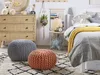 A cozy bedroom scene with a bed, dresser, and decorative items. Produktbild-Vorschau