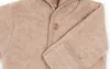 A close-up view of a beige baby overall made of soft fabric. Produktbild-Vorschau