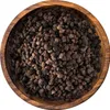 A close-up, top-down view of whole cardamom seeds in a wooden bowl. Produktbild-Vorschau