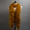 A gold feather boa is displayed on a mannequin against a gray background. Anteprima dell’immagine prodotto