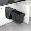 A pull-out trash bin system with three compartments is installed inside a kitchen cabinet. Voir les images du produit