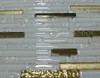 A close-up view of a mosaic tile wall with alternating white, clear, and gold rectangular tiles. Náhľad obrázku produktu
