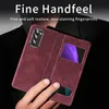 A person's hand is holding a red phone case with a view window, showcasing the phone inside. Produktbild-Vorschau