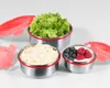 Three stainless steel food storage containers with red lids, filled with different foods. Produktbild-Vorschau