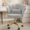 A gray velvet office chair with a gold base and wheels, placed in front of a white vanity table with a lighted mirror. Produktbild-Vorschau