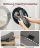 A collage showing a gray fabric cover being put into a washing machine, and close-ups of the cover's fasteners and removable design. Produktbild-Vorschau