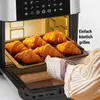 Croissants are being taken out of an air fryer. Produktbild-Vorschau