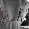 Close-up of the back of a person wearing gray overalls with orange stitching. Produktbild-Vorschau