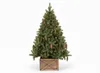 A decorated Christmas tree in a wooden stand against a white background. Voir les images du produit