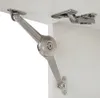 Close-up of a cabinet hinge mechanism attached to a white cabinet. Náhled obrázku produktu