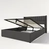 A dark gray upholstered bed frame with the mattress support mechanism lifted to reveal storage space underneath. Produktbild-Vorschau