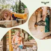 A collage of three images showing children playing on a wooden playground structure. One image shows a girl looking through a telescope, another shows a girl playing in a sandbox, and the third shows someone climbing a wall with climbing holds. Voir les images du produit