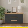 A modern sideboard with wooden top and dark gray drawers and doors, placed in a room with decorative items and a plant. Voir les images du produit