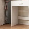 A close-up view of a white vanity with a drawer and shelves, next to draped curtains. Náhled obrázku produktu