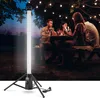 People enjoying a meal outdoors at night, illuminated by a tall LED work light. Produktbild-Vorschau