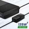 A close-up shot of an Xbox One power adapter connected to an Xbox One console. Podgląd zdjęcia produktu