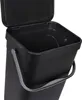 A black hanging trash can with an open lid and a gray handle, shown from a slightly elevated side angle against a white background. Voir les images du produit