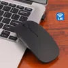 A black wireless mouse is placed on a wooden surface next to a laptop keyboard. Produktbild-Vorschau