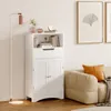 A white bathroom cabinet is shown in a room with a floor lamp and a sofa. Náhled obrázku produktu