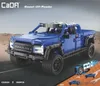 A blue toy truck is shown on a road with a desert background. There are also smaller images showing how the toy works. Náhľad obrázku produktu