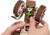Hands assembling a wooden 3D puzzle model of a tractor. Náhľad obrázku produktu