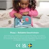 A young girl is playing with a Bluey-themed toy suitcase and tea set. Produktbild-Vorschau