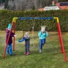 Three children are playing on a swing set in a backyard. Voir les images du produit
