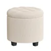A round, cream-colored ottoman with a tufted top and four black legs, shown against a white background. Produktbild-Vorschau