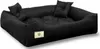 A black dog bed with two small pillows.