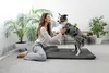 A woman is playing with her dog on a dog bed indoors. Náhľad obrázku produktu