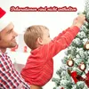 A father and son decorating a Christmas tree. Produktbild-Vorschau
