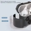 A close-up view of a gray earphone case with white earphones inside, showcasing its material layers. Produktbild-Vorschau