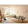 A modern living room with a sofa, coffee table, dining set, and a fan. Produktbild-Vorschau