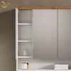 A close-up view of a white bathroom cabinet with wooden trim, showing open shelves and mirrored doors. Anteprima dell’immagine prodotto