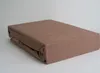 A folded fitted sheet is placed on a plain background. Produktbild-Vorschau