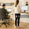 A split image showing a man sitting at a standing desk and a woman standing at a standing desk, both working on laptops or computers. Produktbild-Vorschau