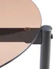 Close-up of a round glass tabletop and its metal support structure. Voir les images du produit