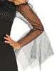 Close-up of a person's arm wearing a black dress with sheer, polka-dot sleeves. Produktbild-Vorschau
