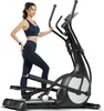 A woman is using an elliptical cross trainer. Produktbild-Vorschau