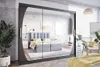 A bedroom scene featuring a large mirrored wardrobe with sliding doors, reflecting a bed and other bedroom furniture. Produktbild-Vorschau