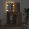 A makeup vanity with a lighted mirror and drawers, a stool, and a basket. Náhľad obrázku produktu