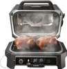 An open electric grill with two roasted chickens inside, emitting steam. Voir les images du produit