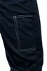 A close-up view of a navy blue work pant pocket with white stitching. Podgląd zdjęcia produktu