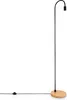 A minimalist floor lamp with a black stem and a wooden base, set against a white background. Produktbild-Vorschau