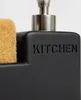 A close-up of a black soap dispenser with the word "KITCHEN" embossed on it, and a tan sponge next to it. Produktbild-Vorschau